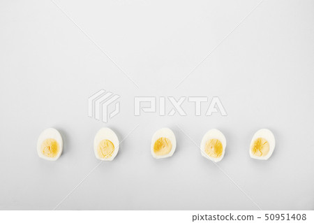 Half of boiled eggs yolk and white on gray 50951408