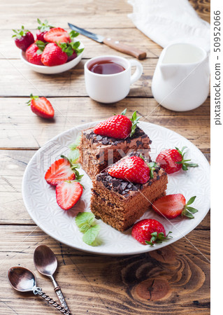 Chocolate truffle cake with strawberries and mint. Chocolate truffle cake with strawberries and mint. 50952066