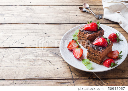 Chocolate truffle cake with strawberries and mint. Chocolate truffle cake with strawberries and mint. 50952067