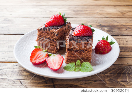 Chocolate truffle cake with strawberries and mint. 50952074