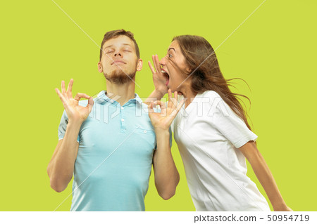 Beautiful couple isolated on green studio background 50954719