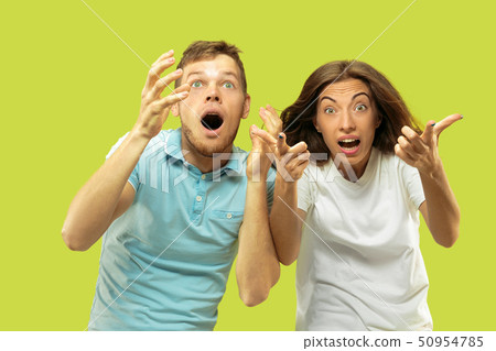 Beautiful couple isolated on green studio background Beautiful couple isolated on green studio background 50954785