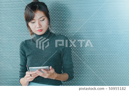 close up of asian business woman working on tablet 50955182
