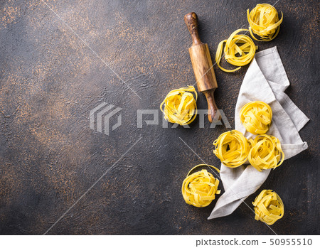 Raw pasta tagliatelle or fettuccine 50955510