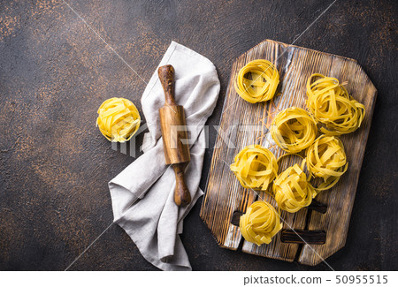 Raw pasta tagliatelle or fettuccine 50955515