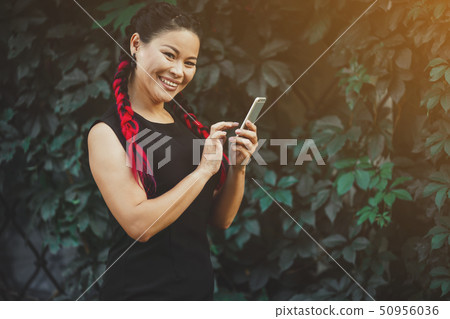 Beautiful Mature Asian Female Model with Smartphone Outdoor Beautiful Mature Asian Female Model with Smartphone Outdoor 50956036