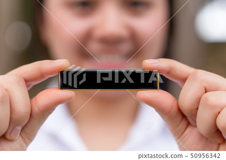 closeup girl hand holding blank label space closeup girl hand holding blank label space 50956342