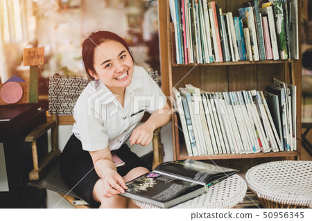 university uniform girl teen reading a book  50956345