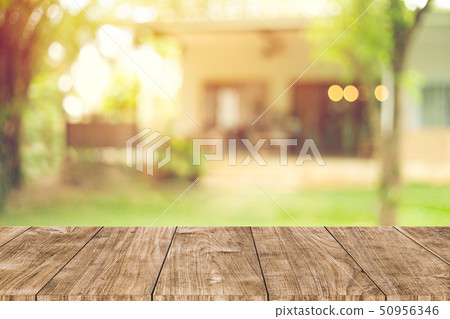 wooden table space with green home backyard view 50956346