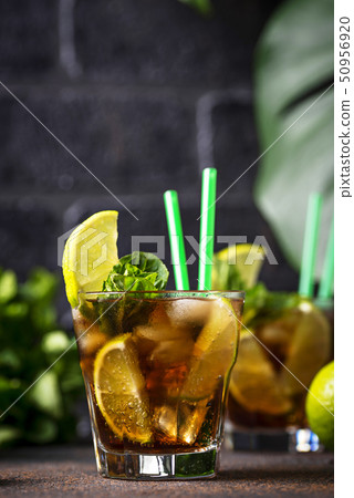 Cuba libre cocktail with mint and lime Cuba libre cocktail with mint and lime 50956920