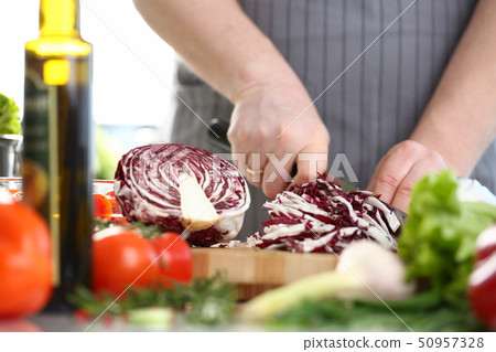 Professional Male Chef Chopping Purple Cabbage Professional Male Chef Chopping Purple Cabbage 50957328