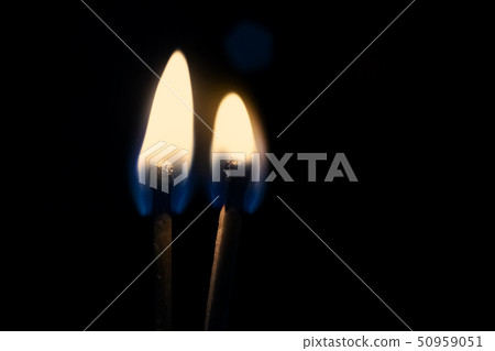 Two burning matches in the dark close up 50959051
