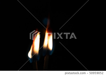 Two burning matches in the dark close up 50959052