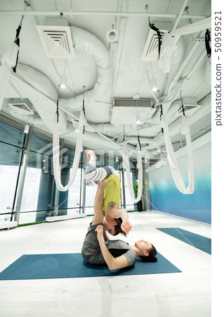 Couple showing amazing yoga poses while practicing together Couple showing amazing yoga poses while practicing together 50959521
