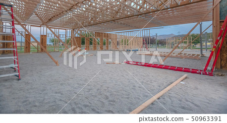 Wooden beams and red ladders in yard pano Wooden beams and red ladders in yard pano 50963391