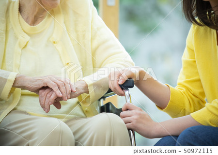 Senior lady and young lady in wheelchair Senior lady and young lady in wheelchair 50972115