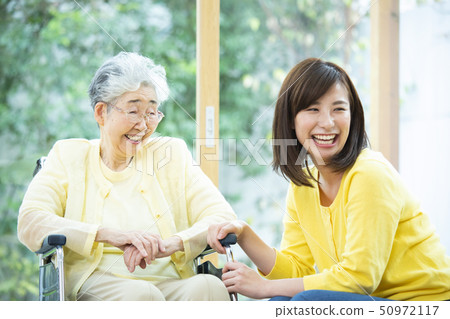 Senior lady and young lady in wheelchair Senior lady and young lady in wheelchair 50972117