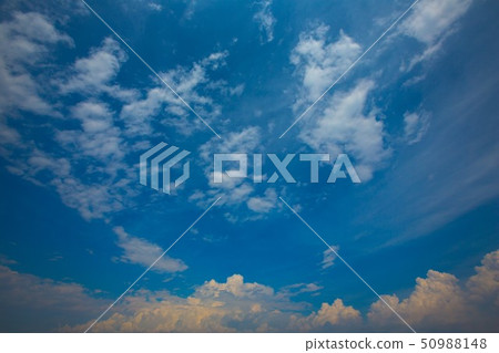 Clouds soaring in the sky, clear blue sky 50988148
