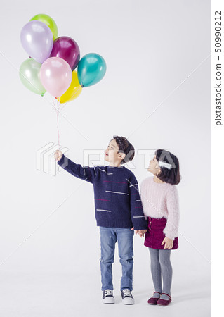 Cheerful boy and a girl on the white background 163 50990212