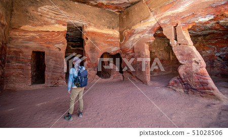 Asian man traveler in dwelling homes of Petra Asian man traveler in dwelling homes of Petra 51028506
