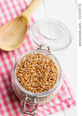 Dry bulgur wheat grains. Dry bulgur wheat grains. 51038778