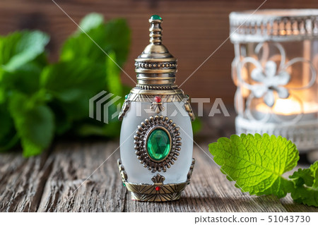 A bottle of melissa essential oil with melissa 51043730