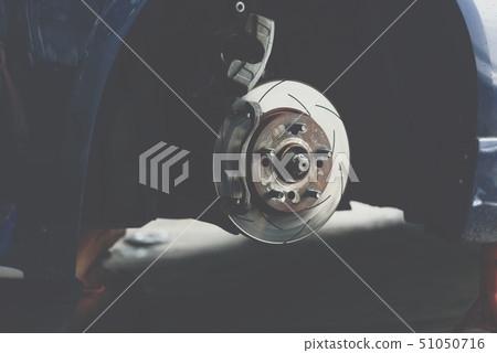 Disc brake and asbestos brake pads at car garage Disc brake and asbestos brake pads at car garage 51050716