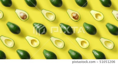 Avocado pattern on yellow background. Pop art design, creative summer food concept. Green avocadoes 51051206