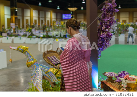 Thai woman making a garland Thai woman making a garland 51052451