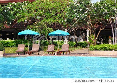 pool bed beside swimming pool in resort. 51054033