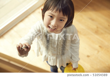 Girl going to easel in the living room Girl going to easel in the living room 51054389