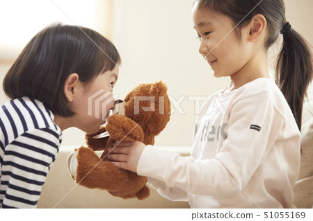 Kids playing with little bears on the couch Kids playing with little bears on the couch 51055169