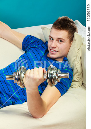 Young man fit body relaxing on couch after 51059889