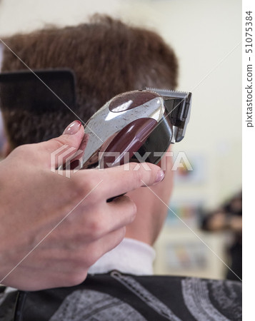 Barber trim man client with clipper machine 51075384