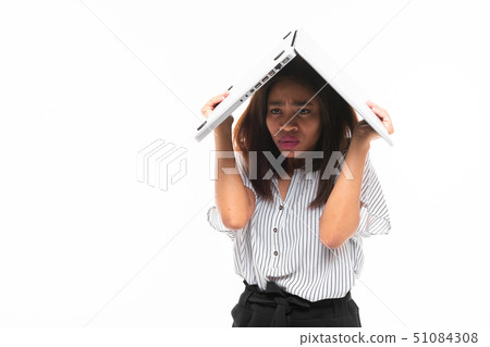 unconfident dark-skinned young girl covered with laptop isolated on background 51084308