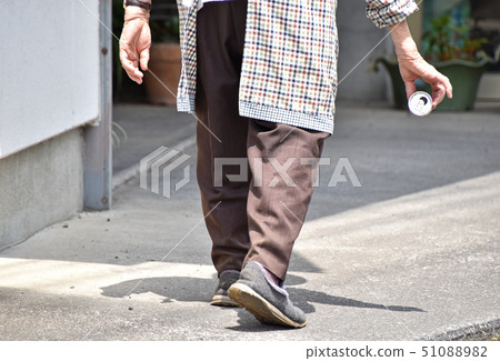 Senior taking a litter of empty cans 51088982