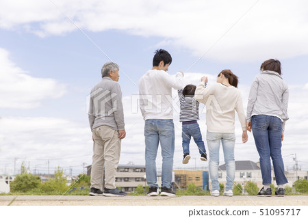 Back view of a three generation family 51095717