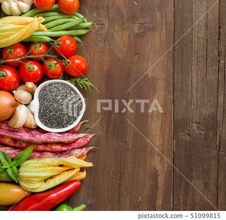 Raw chia seeds in a bowl and fresh vegetables 51099815