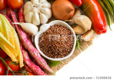 Red rice in bowl and fresh vegetables Red rice in bowl and fresh vegetables 51099838
