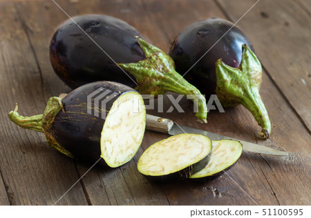 Fresh  Raw eggplants with knife 51100595