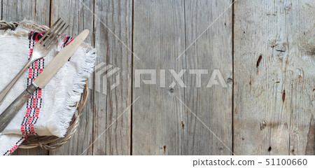 Vintage fork and knife on napkin on old wood 51100660