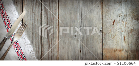 Vintage fork and knife on napkin on old wood 51100664