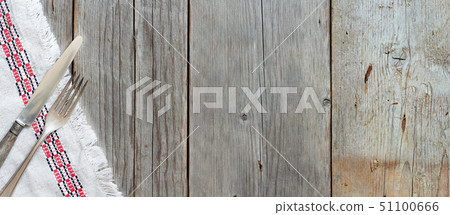 Vintage fork and knife on napkin on old wood 51100666
