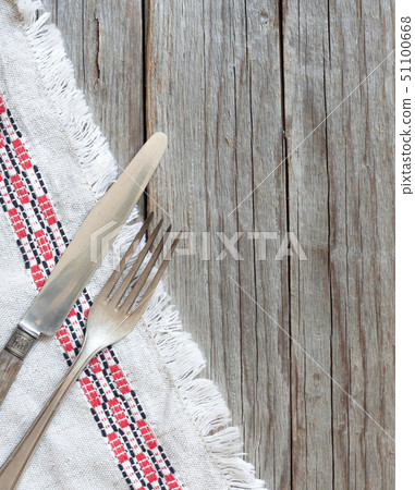 Vintage fork and knife on napkin on old wood 51100668