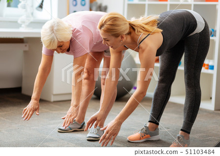 Pleasant good looking woman showing the exercise 51103484