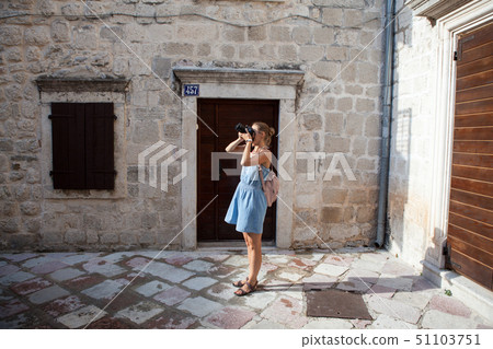 Woman tourist walks through the streets of the old town of Kotor in Montenegro 51103751