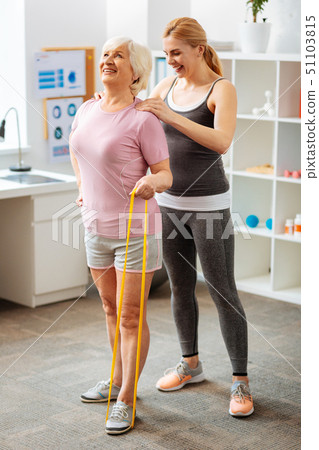 Joyful elderly woman holding a rubber band Joyful elderly woman holding a rubber band 51103815