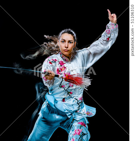 woman Tai Chi Chuan Tadjiquan posture isolated black background light painting  51106310