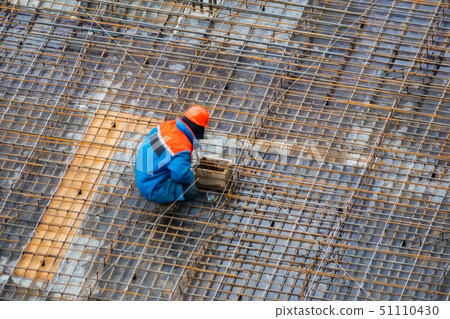 People work with reinforcement carcass made of fitness at construction site People work with reinforcement carcass made of fitness at construction site 51110430