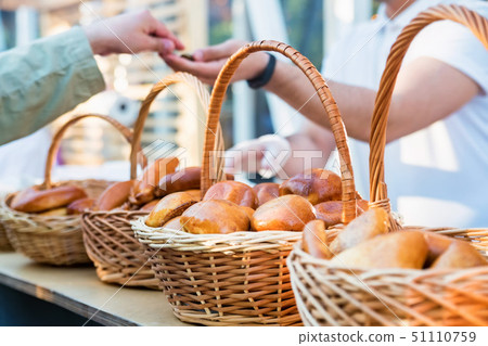 Russian pirozhki, baked patties or pies in basket for sale Russian pirozhki, baked patties or pies in basket for sale 51110759